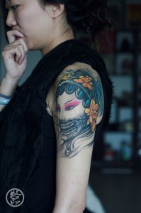 Ghost face tattoo of a woman on Arm