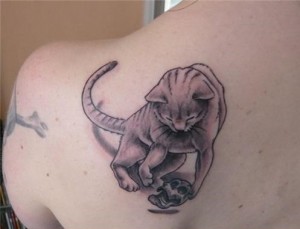 Tattoo:  Cat Playing With Human Skull